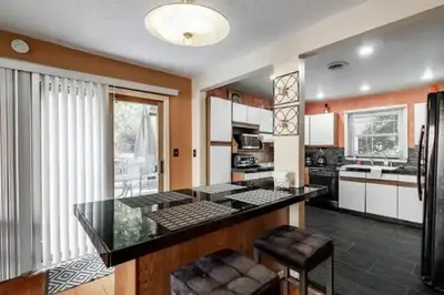 a kitchen with a black counter top in a room at Spacious Family Getaway - Near Cleveland Clinic in Cleveland