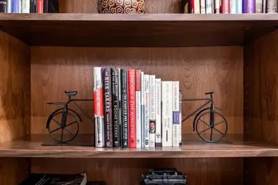 a row of books on a book shelf at Spacious Family Getaway - Near Cleveland Clinic in Cleveland