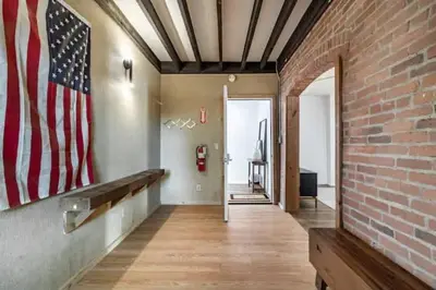 an empty hallway with an american flag on the wall at Cute 1Bed Loft at The Foundry - Steps to Riverside in Cleveland