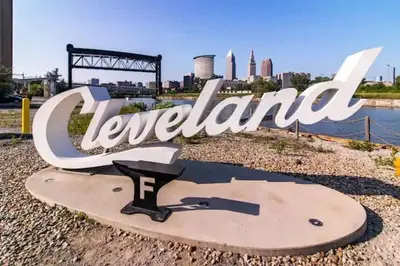 a sign that reads leeland with a city in the background at Cute 1Bed Loft at The Foundry - Steps to Riverside in Cleveland