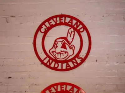 a red sign on a brick wall with a demon at Lakefront Loft - Walk 2 First Energy x Progressive in Cleveland