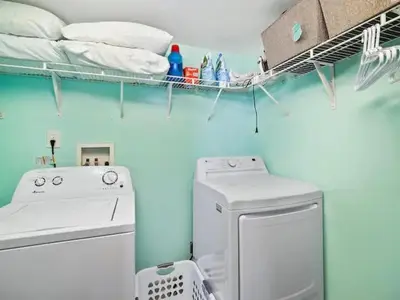 a laundry room with a washing machine and a shelf at Lakefront Loft - Walk 2 First Energy x Progressive in Cleveland