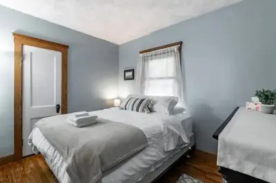 a bedroom with a large bed and a window at Lakewood Bed & Biscuit - Pet Friendly - Mins to LKWD Park in Lakewood