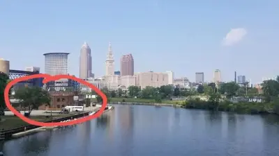 a red circle in the middle of a river with a city at Spacious Riverfront Suite - Close to Downtown in Cleveland