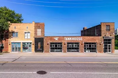 an old brick building with a train house on a street at Spacious Riverfront Suite - Close to Downtown in Cleveland