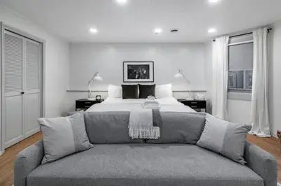 a living room with a bed and a couch at Spacious Riverfront Suite - Close to Downtown in Cleveland