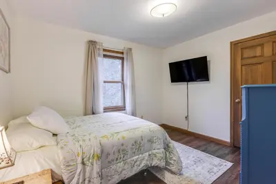 a bedroom with a bed and a flat screen tv at On-Site Lake and Gazebo Cabin in Yellow Springs! in Fairborn