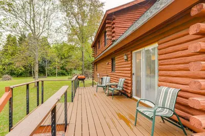 a wooden deck with chairs on a house at On-Site Lake and Gazebo Cabin in Yellow Springs! in Fairborn
