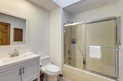 a bathroom with a shower and a toilet and a sink at On-Site Lake and Gazebo Cabin in Yellow Springs! in Fairborn