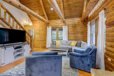a living room with a couch and a tv at On-Site Lake and Gazebo Cabin in Yellow Springs! in Fairborn