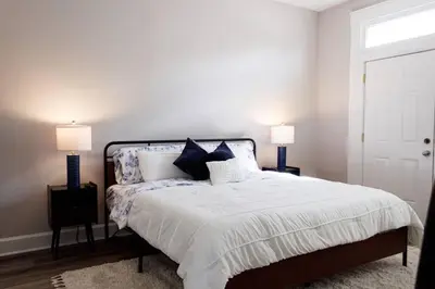 a bedroom with a large bed with two lamps at Lizzys Haven in Cincinnati
