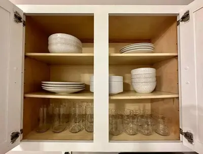 a cabinet filled with dishes and bowls and plates at Lizzys Haven in Cincinnati