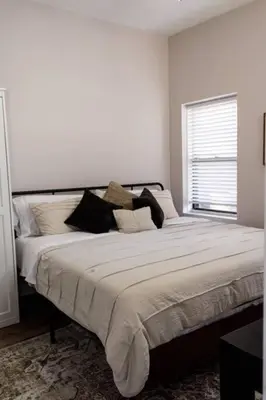 a bedroom with a large bed with pillows on it at Lizzys Haven in Cincinnati