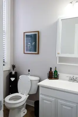a white bathroom with a toilet and a sink at Lizzys Haven in Cincinnati