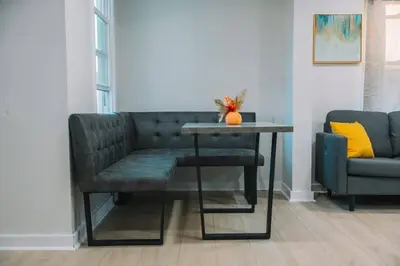 a living room with a couch and a table at Family Friendly Downtown Apple Creek by Antiques in Apple Creek