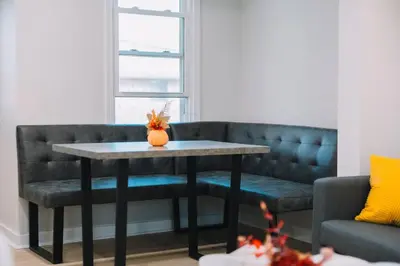 a table and a couch in a living room at Family Friendly Downtown Apple Creek by Antiques in Apple Creek