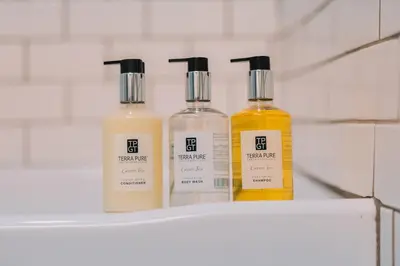 three bottles of moisturizers sitting on a shelf at Family Friendly Downtown Apple Creek by Antiques in Apple Creek