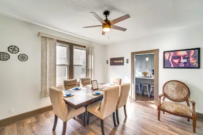 a dining room with a table and chairs and a ceiling fan at 4 Mi to Dtwn Home with Patio in Cleveland! in Cleveland