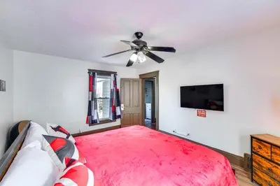 a bedroom with a bed and a ceiling fan at 4 Mi to Dtwn Home with Patio in Cleveland! in Cleveland