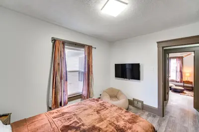 a bedroom with a large bed and a tv at 4 Mi to Dtwn Home with Patio in Cleveland! in Cleveland