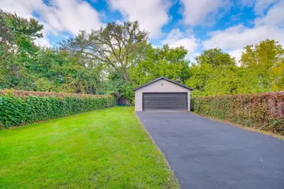 a garage in the middle of a driveway at 4 Mi to Dtwn Home with Patio in Cleveland! in Cleveland