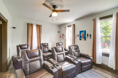 a waiting room with leather chairs and a ceiling fan at 4 Mi to Dtwn Home with Patio in Cleveland! in Cleveland