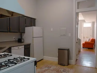 a kitchen with a stove and a white refrigerator at 2 Blocks from TQL Stadium 2BR 1.5BA in Cincinnati