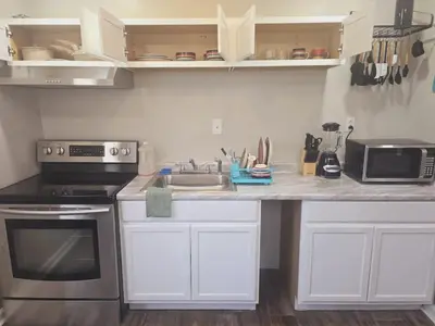 a kitchen with a sink and a stove top oven at Comfy 1BR Apt. in Pleasant Ridge in Cincinnati