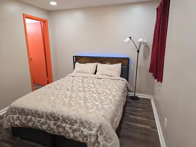 a bedroom with a bed and a lamp at Cozy 1BR in Pleasant Ridge in Cincinnati