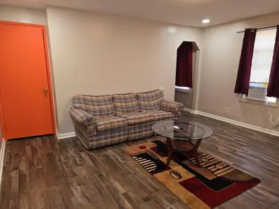 a living room with a couch and a glass table at Cozy 1BR in Pleasant Ridge in Cincinnati