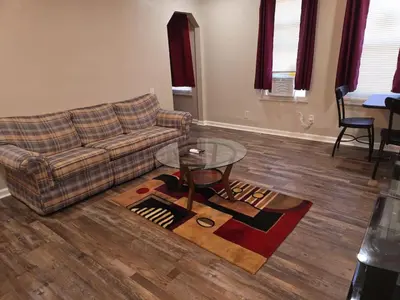 a living room with a couch and a glass table at Cozy 1BR in Pleasant Ridge in Cincinnati