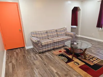a living room with a couch and a glass table at Cozy 1BR in Pleasant Ridge in Cincinnati