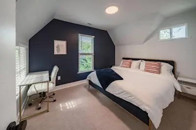 a bedroom with a large bed and a desk at Hot Tub Amazing Location! Modern Ohio City Luxury 2 King Beds in Ohio City