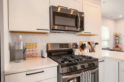 a kitchen with a stove and a microwave at Hot Tub Amazing Location! Modern Ohio City Luxury 2 King Beds in Ohio City