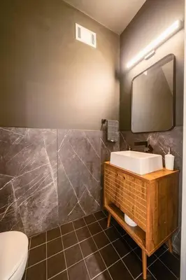 a bathroom with a sink and a mirror and a toilet at Hot Tub Amazing Location! Modern Ohio City Luxury 2 King Beds in Ohio City