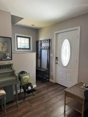 a living room with a piano and a door at Spacious Relaxing Baltimore Home with Hot Tub in Baltimore