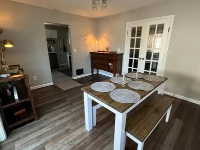 a living room with a table with plates on it at Spacious Relaxing Baltimore Home with Hot Tub in Baltimore