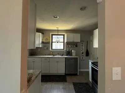 a kitchen with white cabinets and a sink at Spacious Relaxing Baltimore Home with Hot Tub in Baltimore