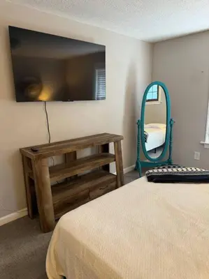 a bedroom with a bed and a large mirror at Spacious Relaxing Baltimore Home with Hot Tub in Baltimore