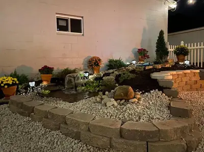 a garden with a pond in front of a house at Spacious Relaxing Baltimore Home with Hot Tub in Baltimore