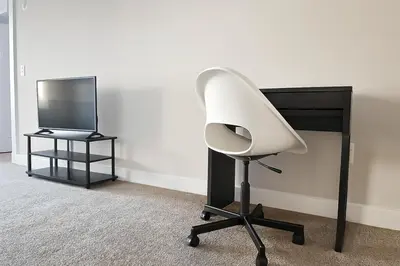 a white office chair sitting next to a desk at Spacious Downtown Sq Stadium, Casino, R&R HoF in Cleveland