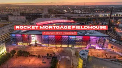 a large building with a soccer field in a city at Spacious Downtown Sq Stadium, Casino, R&R HoF in Cleveland