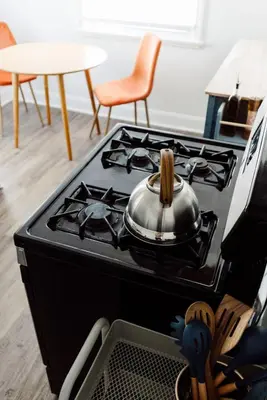 a tea pot sitting on top of a stove at Family Friendly 3BR with Sunroom and Outdoor Area in Maple Heights