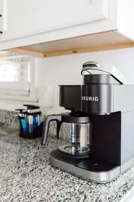 a coffee maker on a counter in a kitchen at Family Friendly 3BR with Sunroom and Outdoor Area in Maple Heights
