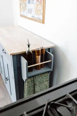 a kitchen counter with a table with bottles on it at Family Friendly 3BR with Sunroom and Outdoor Area in Maple Heights