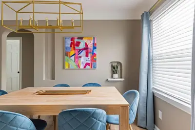 a dining room with a wooden table and blue chairs at 27150 Forestview Ave, Euclid in Euclid