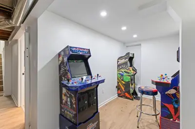 a room with a video game system and two arcade machines at 27150 Forestview Ave, Euclid in Euclid