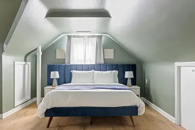 a bed with a blue headboard in a bedroom at 27150 Forestview Ave, Euclid in Euclid