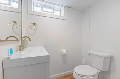 a white bathroom with a toilet and a sink at 27150 Forestview Ave, Euclid in Euclid