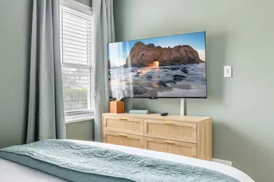 a bedroom with a flat screen tv on the wall at 27150 Forestview Ave, Euclid in Euclid